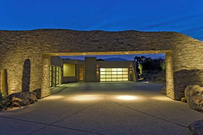 Picture of concrete driveway with lighted garage entryway